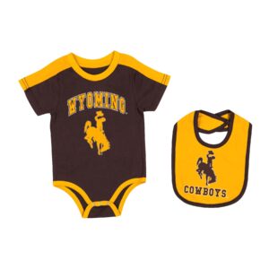 Infant onesie and bib set. Brown onesie with gold trim and shoulders. Wyoming in gold, arced with bucking horse under. Bib is gold with brown trim with Brown bucking horse and cowboys.