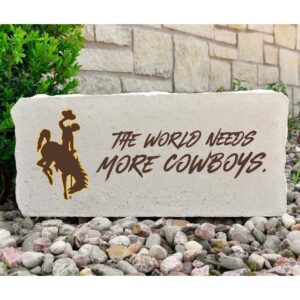 16x7 inch rectangular stone. Bucking horse on right side in brown with gold outline. To the right, slogan, the world needs more cowboys in brown