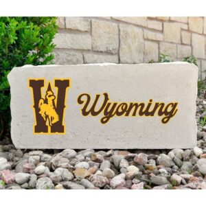 rectangular 16x7 inch stone. Script wyoming in brown with gold outline to the left. Big W with bucking horse in center of W. W is brown, bucking horse is gold.
