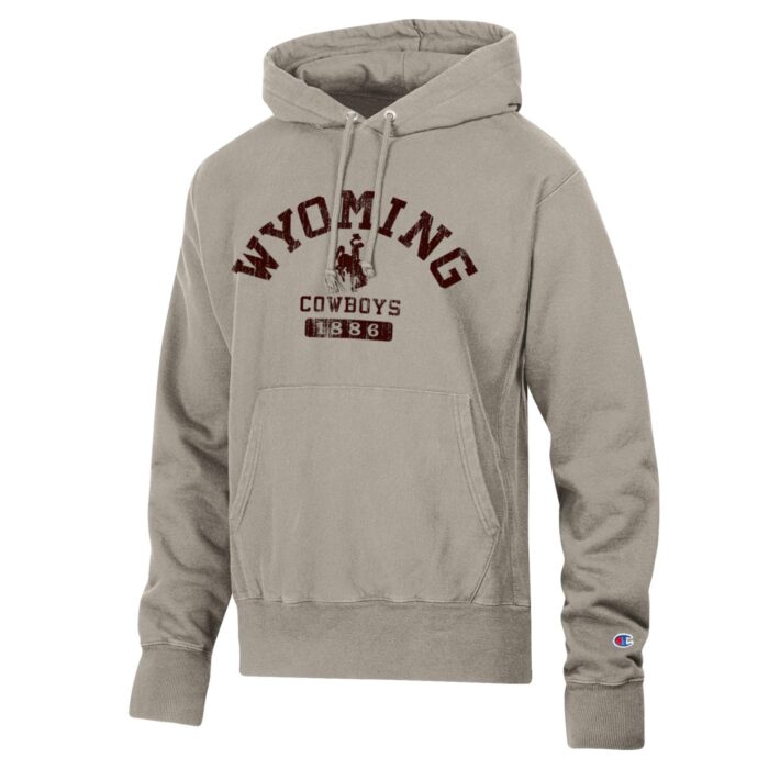 beige hooded sweatshirt with design on front. Design is wyoming arced with bucking horse and cowboys under. Design is all in brown.