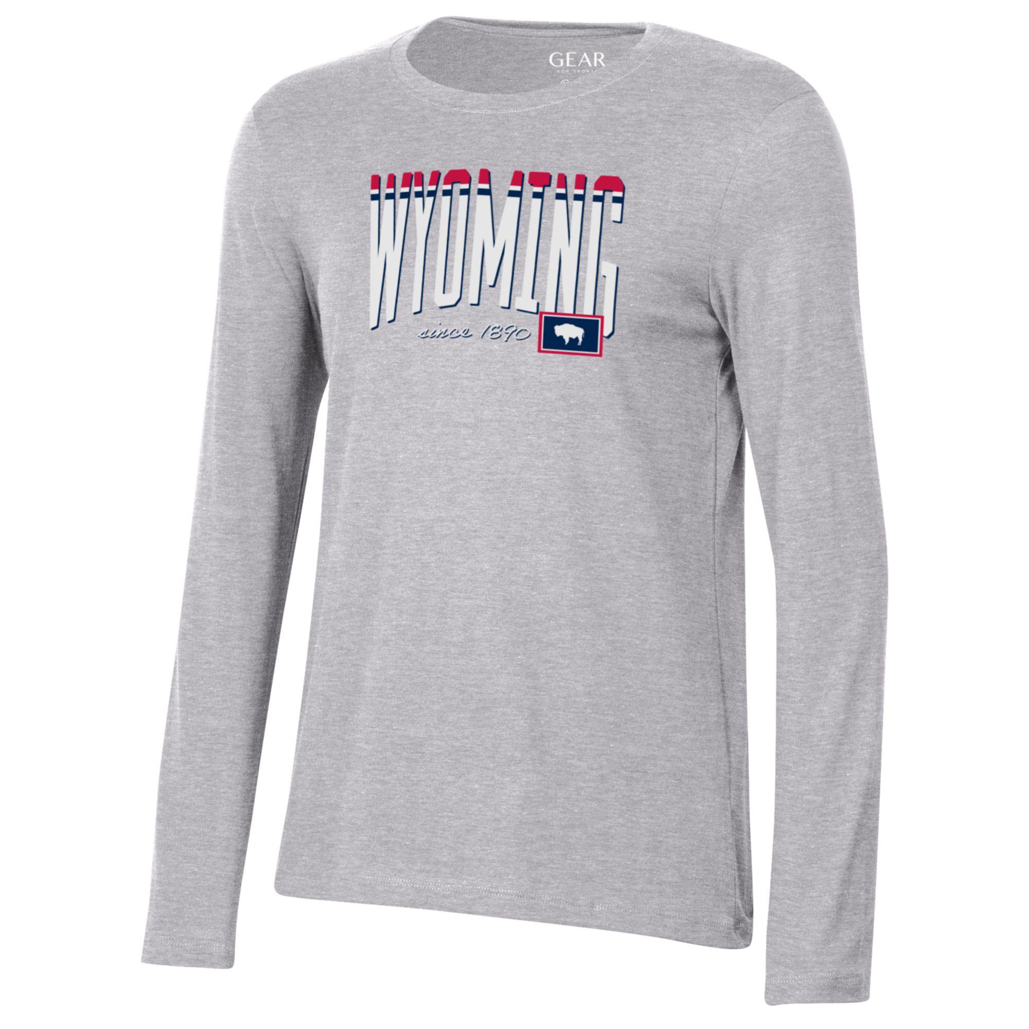 Grey women's long sleeve t-shirt. Wyoming on center chest in white, red and blue, with state flag in lower left corner. Design is center chest.