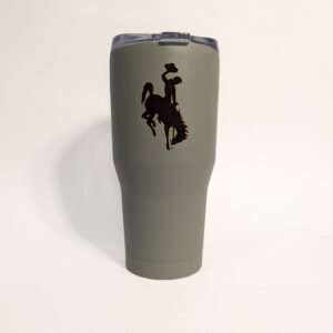grey 30-ounce tumbler with brown bucking horse with gold outline and wyoming in brown with gold outline.