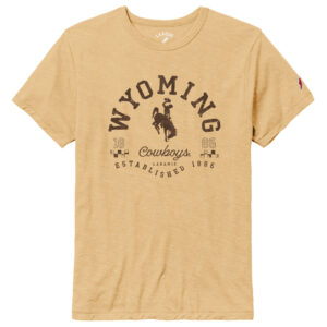 gold short sleeve t-shirt, with brown design on front. Wyoming in half circle shape with bucking horse under. Script cowboys under bucking horse with established 1886 under. Design is center chest