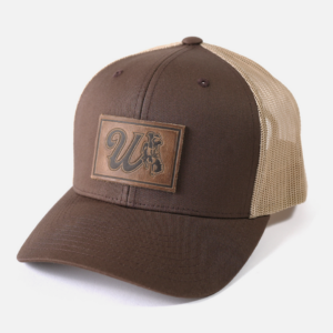 Brown snapback adjustable hat with patch on front. Patch is brown with cursive W and bucking horse with state flag.