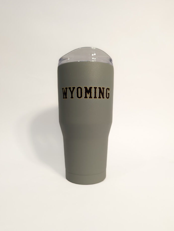 grey 30-ounce tumbler with brown bucking horse with gold outline and wyoming in brown with gold outline.