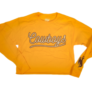 Gold long sleeve crop top with script bubble text, cowboy in white with brown outline. Design is large on center chest. Brown bucking horse on left wrist