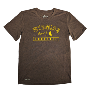 Brown short sleeve tee with arced wyoming in gold outline near neck with bucking horse and nike swoosh under. under is football in gold boxed in.