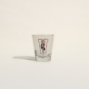 clear shot glass with design on two sides. design is red outline of W with a bucking horse in center of W. Bucking horse has state flag.