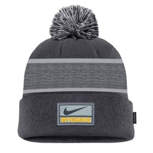 dark grey hat with black and white pom at top and light grey stripe in center of hat. gold bucking horse one side and nike swoosh with wyoming on other