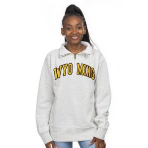 white quarter zip jacket with embroidered design on front. design is gold arced wyoming with brown outline center chest.