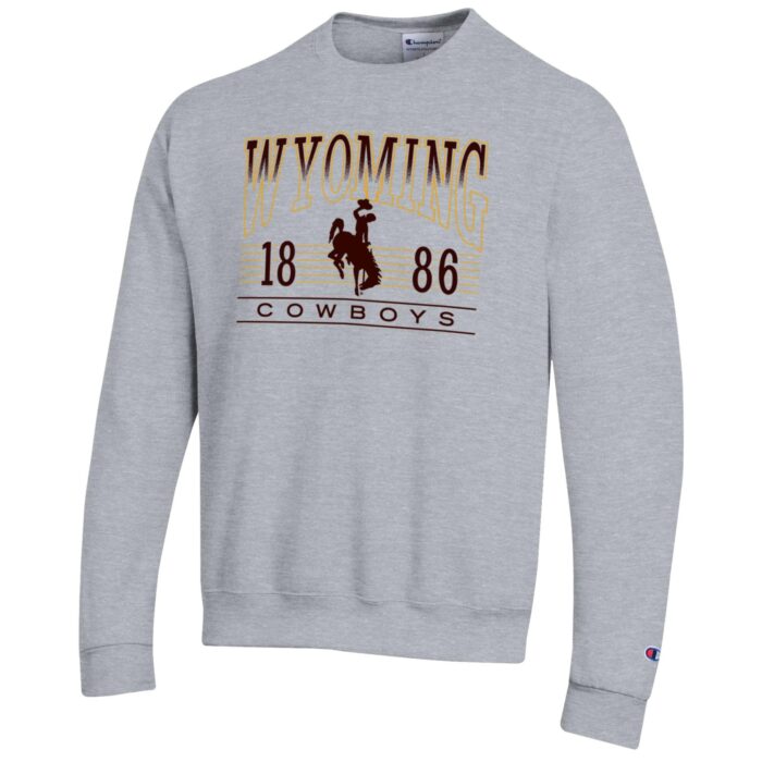 grey crewneck sweatshirt with design center chest. arced wyoming in gold outline with top half filled with brown, bucking horse, 1886, cowboys under arc in brown