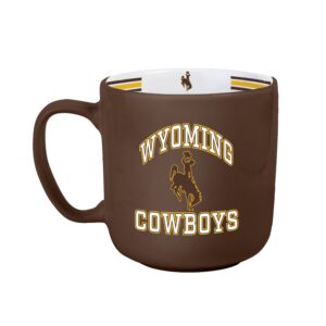 brown and white mug with design on one side and cup interior. Arced wyoming with bucking horse under and cowboys at bottom, all in white with gold outline. Gold and brown stripes inside rim with bucking horse