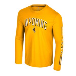 gold long sleeve tee with design on front and left sleeve. on front is arced Wyoming in white and brown with brown bucking horse under. cowboys in white on sleeve