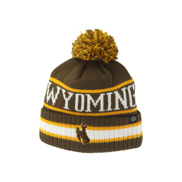 brown knit hat with pom-pom and cuff. Wyoming on head in white with gold stripes on top and bottom. on cuff is white and brown with gold stripes and brown bucking horse patch