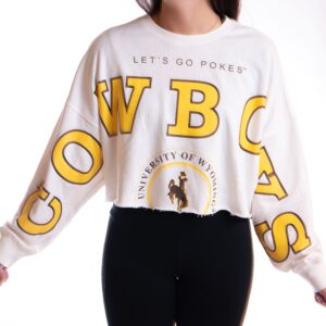 white cropped crewneck sweatshirt with design stretching from right sleeve, across chest, down left arm. Design is cowboys in gold with brown outline, lets go pokes above on center chest