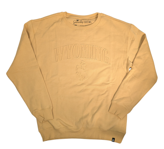 light mustard gold with an embossed design, center chest. Arced outline Wyoming, tonal gold with bucking horse under in tonal gold.