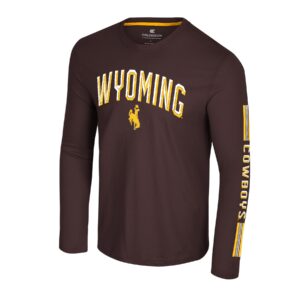 brown long sleeve tee with design on front and left sleeve. on front is arced Wyoming in white and gold with gold bucking horse under. cowboys in gold on sleeve