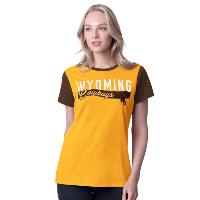 brown and gold short sleeve tee with design center chest. across chest, white, wyoming with gold script cowboys under with brown stripe behind. body is gold shoulders are brown