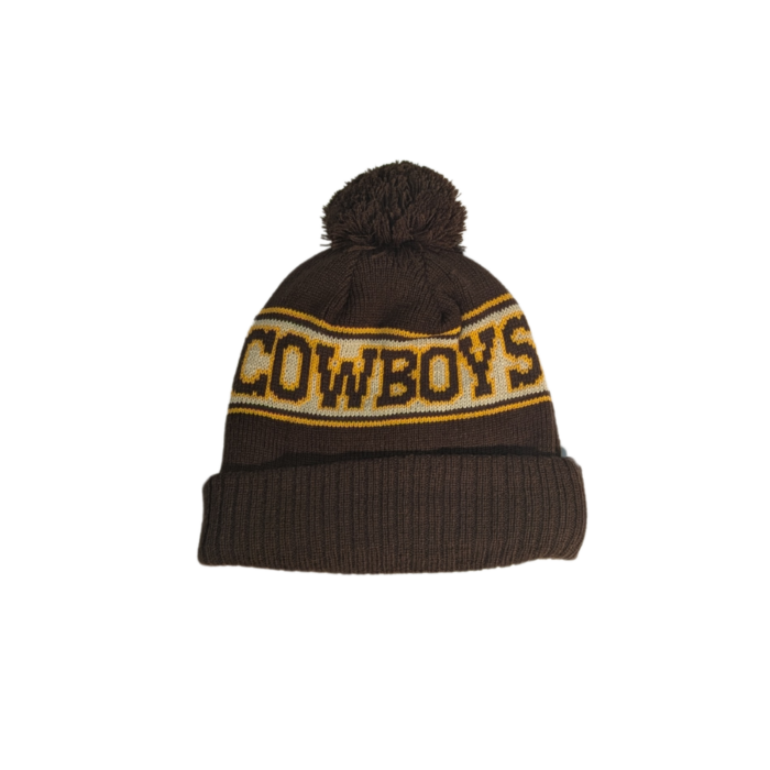 brown beanie with brown pom and cuff. around center head, lighter brown back with Wyoming on front and cowboys on back in dark brown with gold outline. white embroidered bucking horse on cuff
