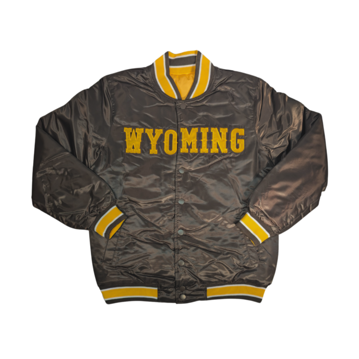 Front of brown satin jacket. full button up with patch Wyoming across center chest with embroidered edging. Cuffed accent on wrist, waist and neck