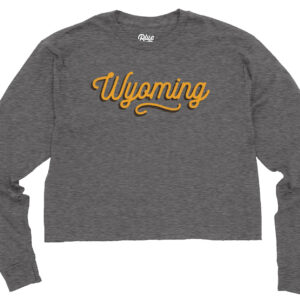 grey womens cropped long sleeve with gold wyoming script with brown shadow centered on the chest.