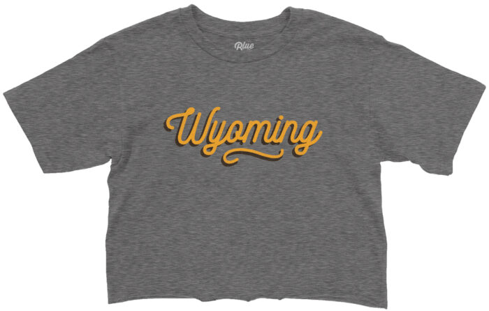 grey womens cropped short sleeve with gold wyoming script with brown shadow centered on the chest.