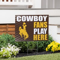 brown yard sign with stakes, design is "cowboy fans play here" alternating white and gold lettering, with a gold bucking horse on the left of the words