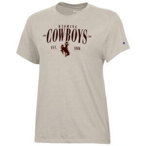 tan tee shirt with brown design center chest. design is small wyoming with big cowboys under and est.1886 with bucking horse below that