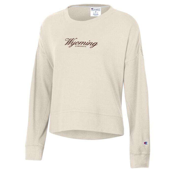 ivory women's champion crewneck with small brown design center chest. design is script wyoming with cowboys lettering below