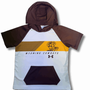 front of youth under armour hooded tee. has white body and brown sleeves, hood, and pocket. has gold strop with brown pistol pete and lines in it. says wyoming cowboys below.