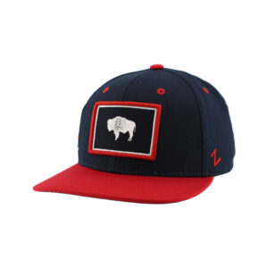 navy hat with red bill. has wyoming and lines on the right side. has a embroidered state flag patch on front panel