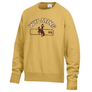 gold champion creneck with design center chest. design is white wyoming letters with brown box shadow. has brown bucking horse below with 86 left centered