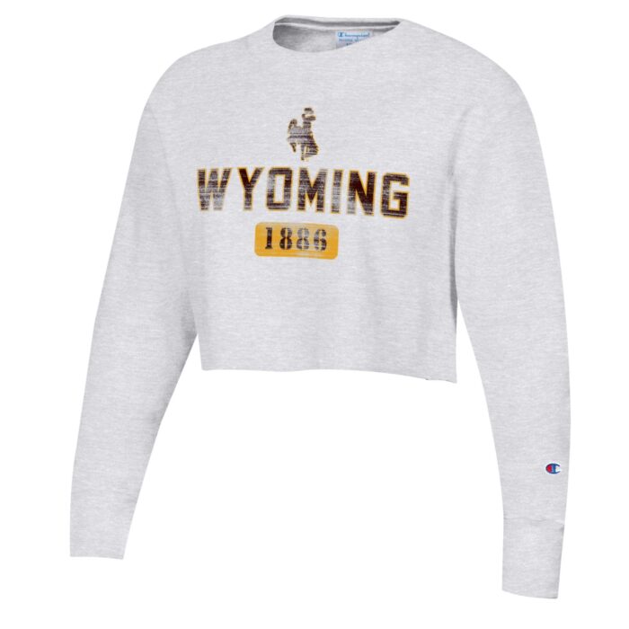 cropped women's crewneck wtih design center chest. design is brown bucking horse with wyoming lettering below all outlined in gold. has 1886 in brown with gold bubble around