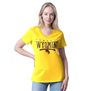 gold women's v-neck tee with brown design center chest. has wyoming lettering with cowboys above and bucking horse below