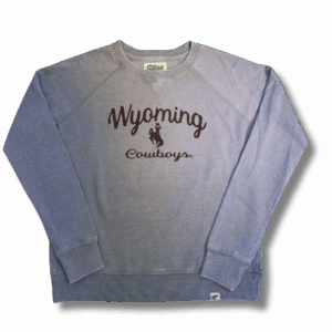 grey women's crewneck. has brown design center chest. design is brown wyoming script with bucking horse below and then cowboys script below that