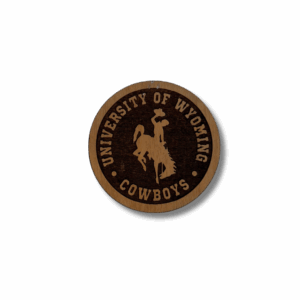 circle wooden magnet with etched design. design is university of wyoming arched with bucking horse below and cowboys below that