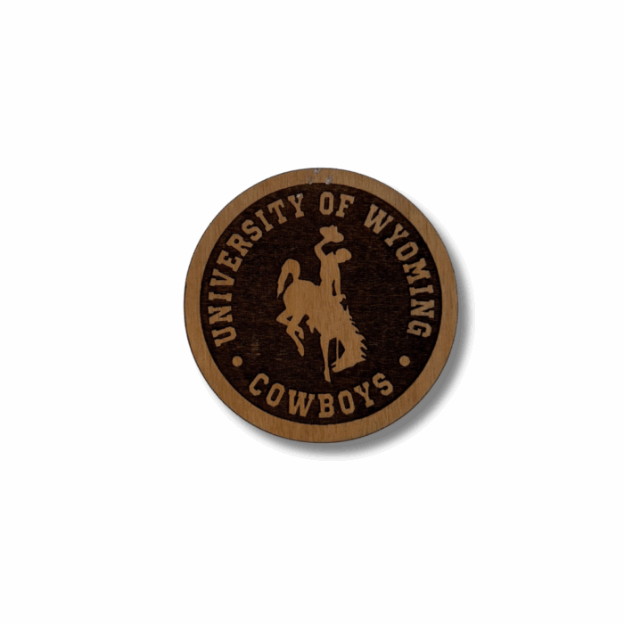 circle wooden magnet with etched design. design is university of wyoming arched with bucking horse below and cowboys below that