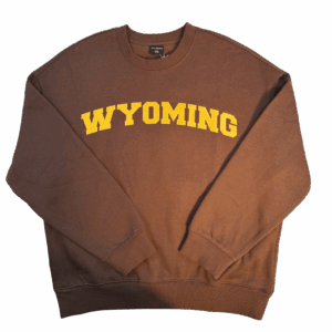 brown women's oversized crewneck with gold design center chest. design is embroidered wyo letters