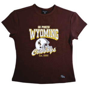 women's brown tee with design center chest. design is white wyoming lettering above white helmet with cowboys script below. all has gold drop shadow.