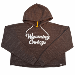 womens brown cropped hooded sweatshirt with white speckles all over it. has white script wyoming cowboys embroidered center chest and has two white strings attached to hood
