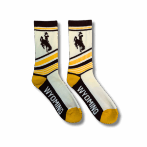 Pair of socks with gold brown and white design all over. has brown bucking horse on ankle and wyoming lettering on bottom of foot in white. toe and heel is gold. rest is brown and gold stripes throughout