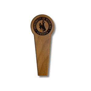 front of wooden bottle opener. has etched university of wyoming with bucking horse below and cowboys below that all in a circle design on the opener