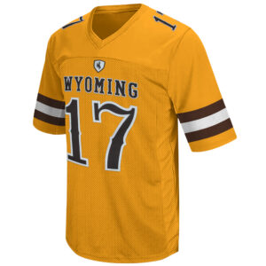 front of gold football jersey, white and brown stripes on sleeves, brown shield with brown bucking horse above gold word Wyoming above brown number 17