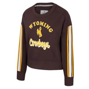 brown womens crewneck with design center chest. design is gold arched wyoming lettering with bucking horse below and scripted cowboys below that in gold. has gold and white horizontal stripes on both sleeves