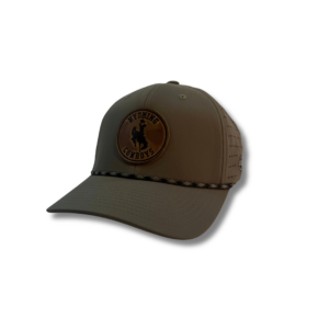 sage adjustable hat with black rope across bill. has circle leather patch on front bill that says wyoming cowboys with bucking horse